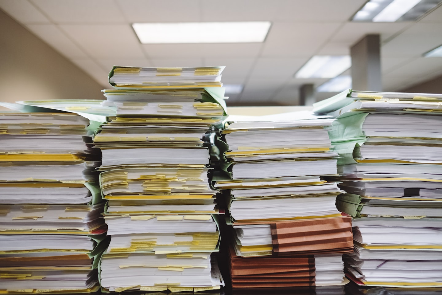 Stacks of documents and files in accordion folders.